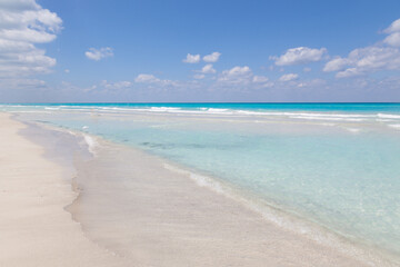 Beach at Cayo Largo is in Cuba. Sandy beach and turquoise ocean water without people are on a sunny day