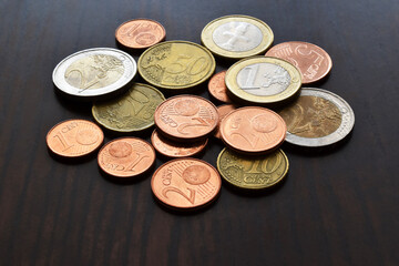 Euro cent coins on wood table.