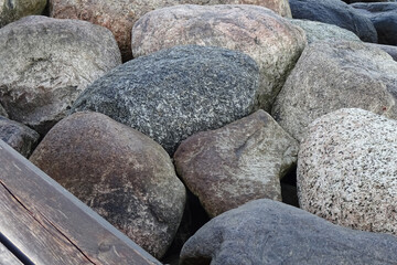 Closeup of a breakwater big grey and light brown stones by the seaside, full frame. Tallinn, Estonia, Europe