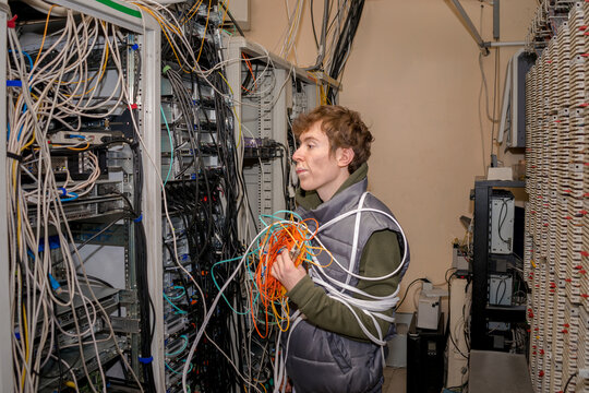 The wired technician pondered in the server room. The installer works in the old datacenter.