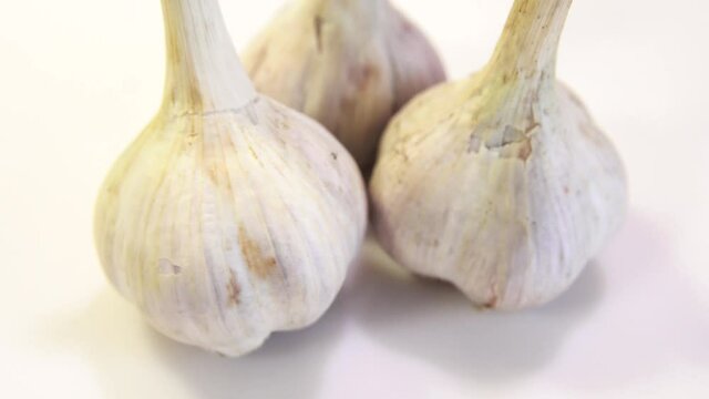 rotating garlic head on wite background.