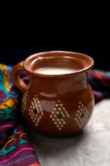Mexican fermented beverage called pulque on a gray background