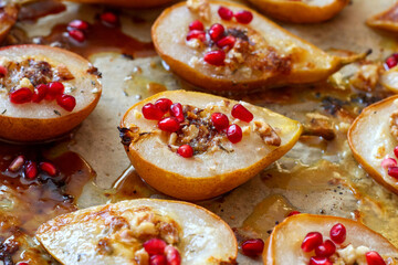 Pears baked with gorgonzola cheese sprinkled with pomegranate seeds