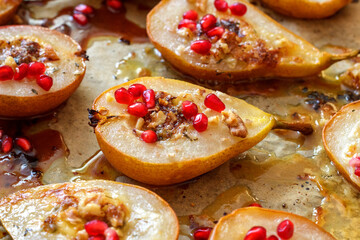 Pears baked with gorgonzola cheese sprinkled with pomegranate seeds