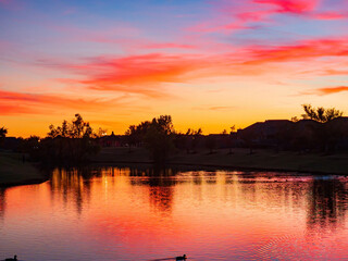 Sunset view of a community lake and residence