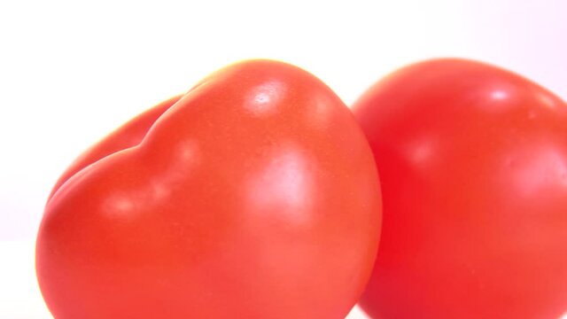 Tomato. Ripe natural tomatoe close-up. Organic tomato rotating on wite background. Macro shot . Garden, Gardening concept