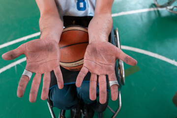 the hands of disabled basketball players after an exhausting game in the arena. Selective focus 
