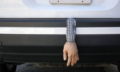 Realistic arm and hand hanging from trunk prank. Fun. Humor. 