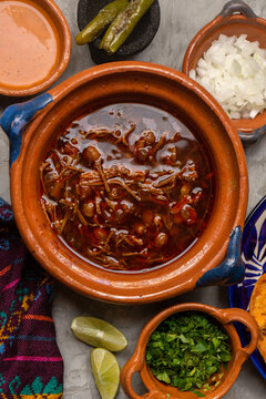 Beef birria with chickpeas on a gray background. Mexican food