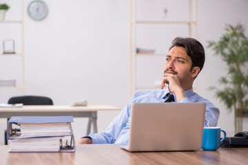 Young male employee working in the office