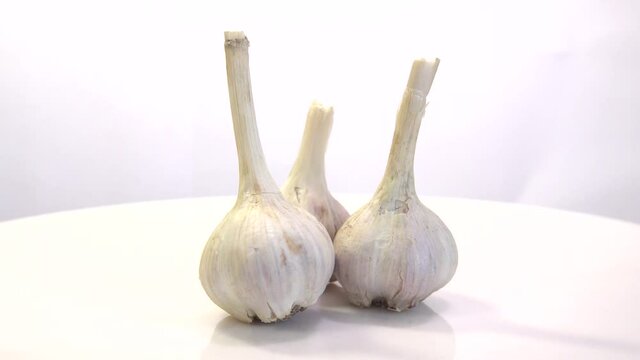 rotating garlic head on wite background.