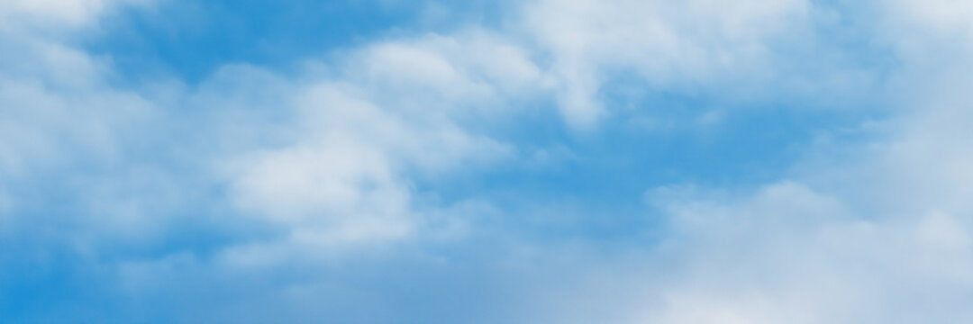 Blue sky background with clouds. Wide panoramic background for design.