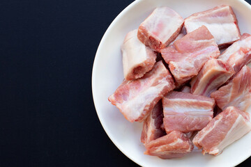 Raw pork ribs on dark background