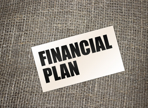 Financial Plan Words On Card On Burlap Canvas. Business Debts Concept