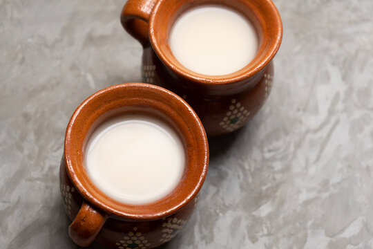 Mexican fermented beverage called pulque on a gray background