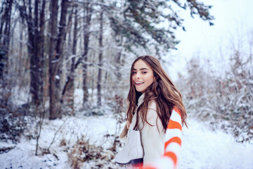 Winter woman. Outdoor close up portrait of young beautiful girl with long hair. Young woman winter portrait.