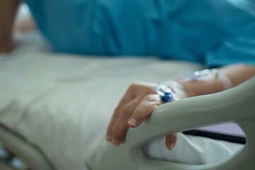giving saline to the hand of an old woman, medical treatment