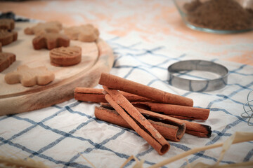Homemade Christmas ginger bread cookies on wooden try with cinnamon, Xmas gingerbread cookie, preparing bakery, process of baking and cooking at home.