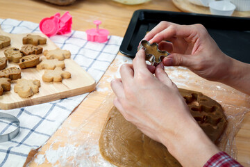 Homemade Christmas cookies, bakery man preparing gingerbread cookies dough, hand cutting dough by cookie mold, food homemade bakery concept