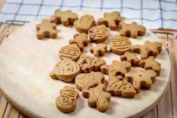 Homemade Christmas ginger bread cookies, Xmas gingerbread cookie on wooden tray, preparing bakery, process of baking and cooking at home