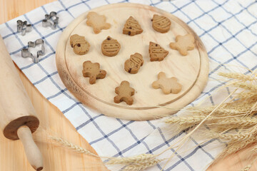 Homemade Christmas ginger bread cookies, Xmas gingerbread cookie on wooden tray, preparing bakery, process of baking and cooking at home