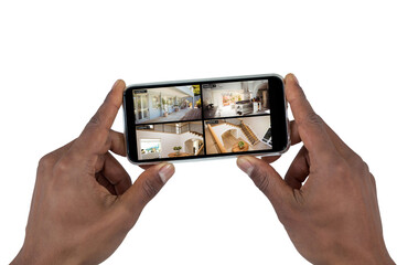 Hands of african american man holding smartphone with view of home from security cameras on screen