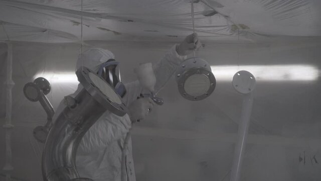 The shipyard masters paint the ship perfectly with the spray paint gun