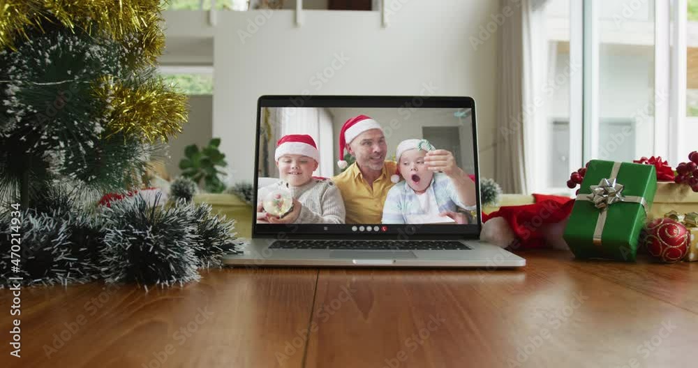 Sticker Smiling caucasian family wearing santa hats on christmas video call on laptop