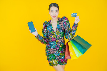 Portrait beautiful young asian woman smile with shopping bag