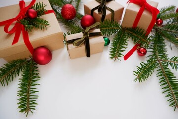 Christmas background with gift boxes and ornaments in white color. Xmas celebration, greetings, preparation for winter holidays. Festive mockup, top view, flat lay with copy space.