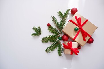 Christmas background with gift boxes and ornaments in white color. Xmas celebration, greetings, preparation for winter holidays. Festive mockup, top view, flat lay with copy space.