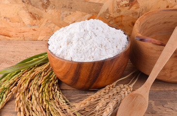 All purpose wheat flour in bowl on wooden background