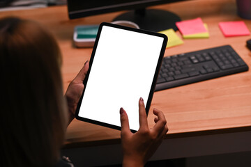 Close up view young woman holding digital tablet with blank display.