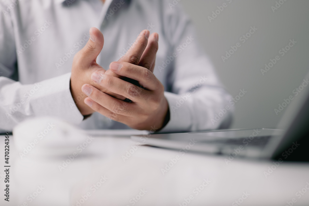 Poster close-up of a man with wrist ache from using a computer. occupational pain causes hand discomfort in