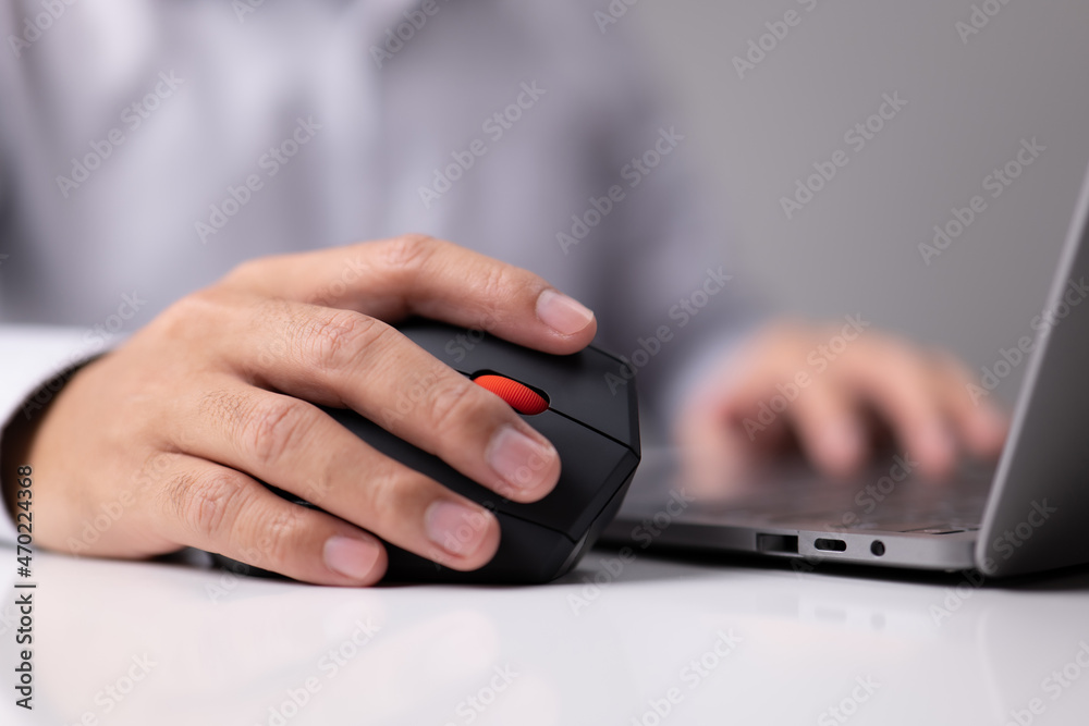 Poster Man hand uses a vertical ergonomic computer mouse joystick.