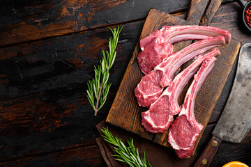 Raw lamb meat chops steaks, on old dark  wooden table background, top view flat lay, with copy...