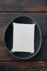 Homemade greek cheese feta, on old wooden table, top view