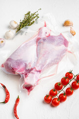 Turkey drumstick meat vacuum pack, on white stone table background