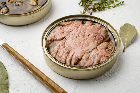 Tuna canned fish seafood, on white stone table background