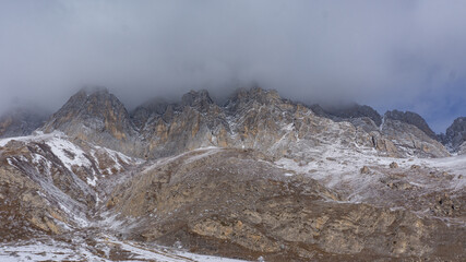 snow covered mountains with fog
