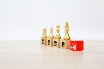 Franchise or franchising, King chess standing with on cube wooden block stack with graph and...