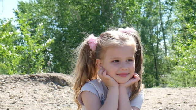 Portrait of smiling pensive little girl.  Enjoying childhood