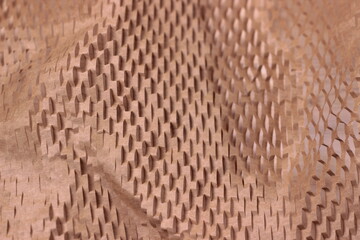 Brown textured cardboard packaging wrapping close up.craft perforated recycling paper background