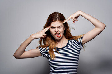 beautiful woman in a striped t-shirt gesture with his hands isolated background