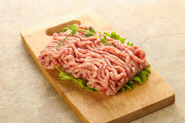 Raw minced pork meat over board