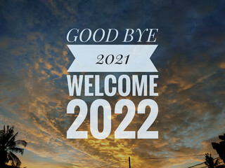 Text GOOD BYE 2021 WELCOME 2022 with nature and sunset background.