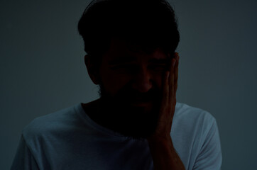 emotional man medicine toothache and health problems light background