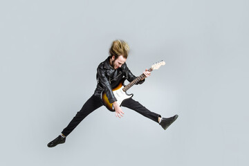 Rock music. Bearded man jump with guitar. Electric guitar. Handsome man with guitar. Brutal man...