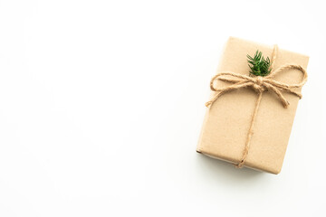 Brown gift box with festive decoration for Christmas and new year is on white background. Top view with copy space, flat lay.