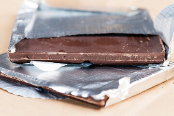 an old chocolate bar on which there are traces of human hands